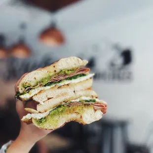 a person holding a sandwich