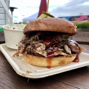 Pulled Pork Sandwich Overnight oak and maple smoked pork, house BBQ sauce, slaw, pickle, challah bun