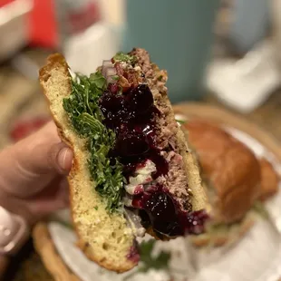 a person holding a sandwich