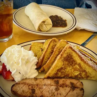 French toast in the front and Breakfast Burrito at the background.