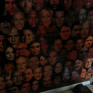 many faces of men on the wall