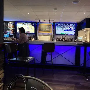 a woman sitting at a bar