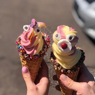 Swirl strawberry and pineapple Dole whip with sprinkles and toffee cones