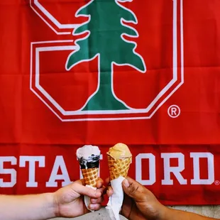 two people holding ice cream cones