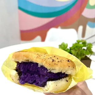 Scoop N&apos; Buns: Glazed Donut Cut in Half with Ube Ice Cream and Oreo Crumbles