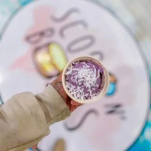 a person holding a bowl of ice cream