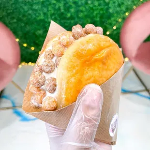  a hand holding a pastry