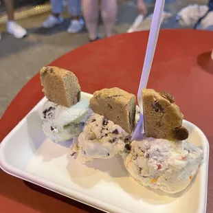 a plate of ice cream and cookies on a table