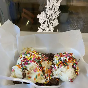 a chocolate covered doughnut with sprinkles