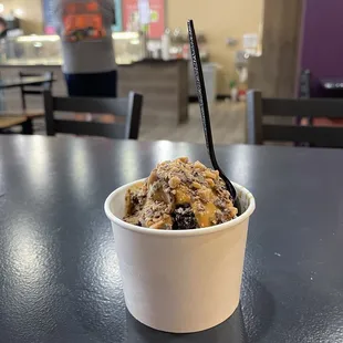 a cup of ice cream with a spoon in it