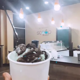 a person holding a bowl of ice cream