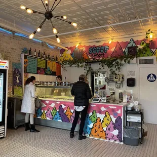 two people standing at a counter