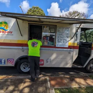 a man standing in front of a food truck