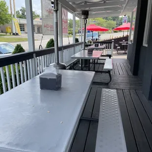 a table and benches on a porch