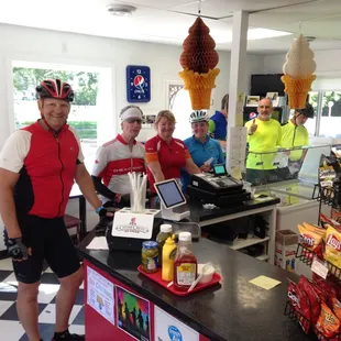 a group of people standing behind a counter