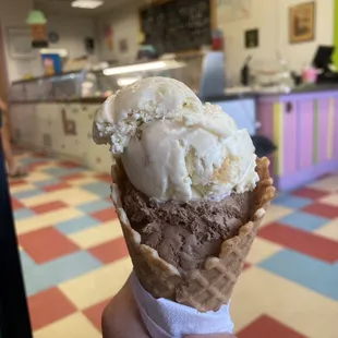 Banana pudding ice cream and mounds ice cream in a waffle cone