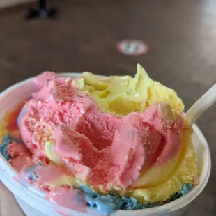 a hand holding a cup of ice cream