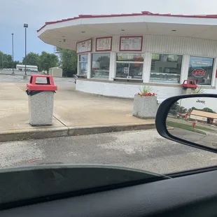 a red truck parked in front of a store