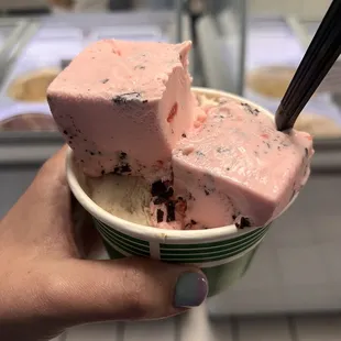 a person holding a bowl of ice cream