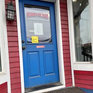 a blue door with a sign on it