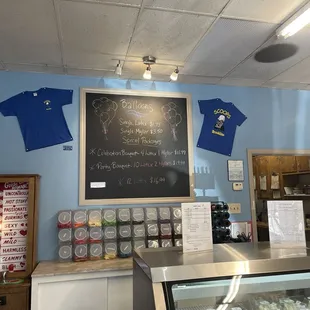 a chalkboard with t - shirts on it
