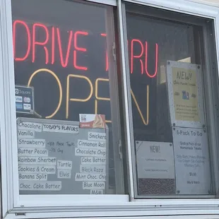 a drive thru open sign in a window
