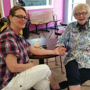 two women sitting at a table in a restaurant