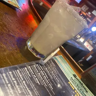 a drink in a tall glass on a table