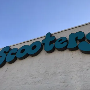 a scooter&apos;s sign on the side of a building