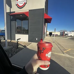 a person holding a cup of coffee