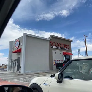 a car parked in front of a coffee shop