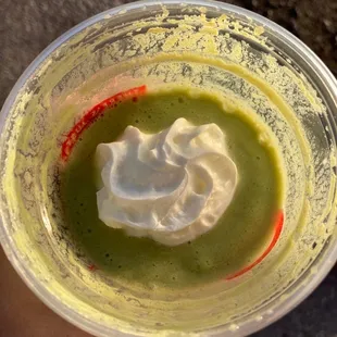 a cup of green tea with whipped cream