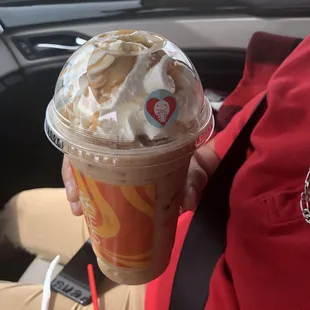 a person holding a cup of coffee