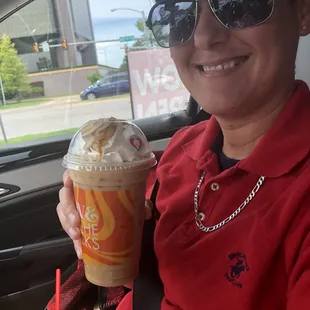 a smiling woman in a car