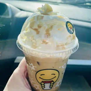 a hand holding a cup of iced coffee