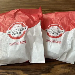 Everything Bagel Sandwich and Bacon Burrito in paper bags