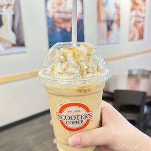 a hand holding a cup of coffee