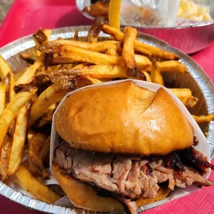 Sliced brisket BBQ sandwich with fries