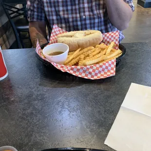 a man sitting at a table with a plate of food