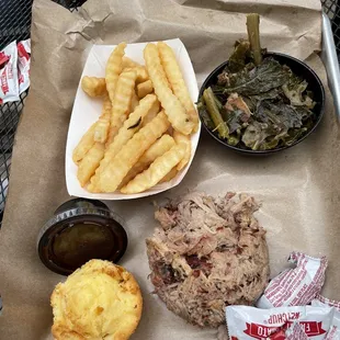 Pork platter with collards and a side of fries
