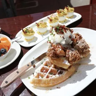 The chicken and waffles brunch dish with deviled eggs on the side.
