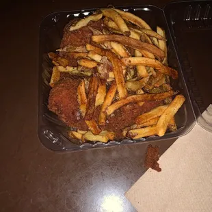 a tray of french fries and a container of ketchup