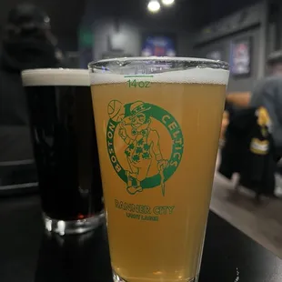 a glass of beer and a pint glass