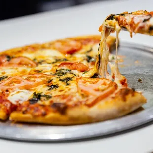 a slice being taken out of a pizza