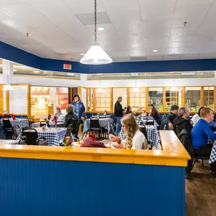 people eating at tables in a restaurant
