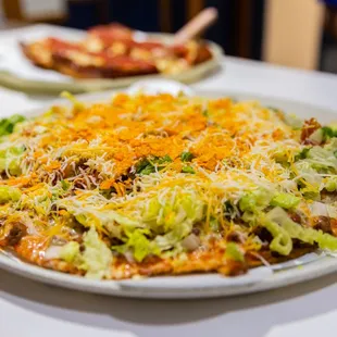 two plates of pizza on a table