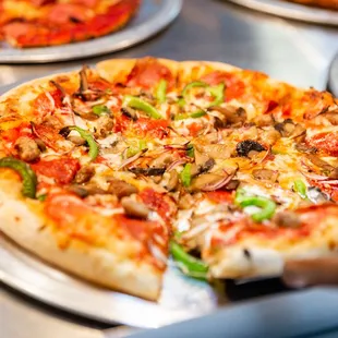 a variety of pizzas on a table