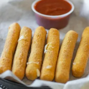 Our homemade cheese sticks, with a side of Side of Scorno&apos;s Pasta Sauce.
