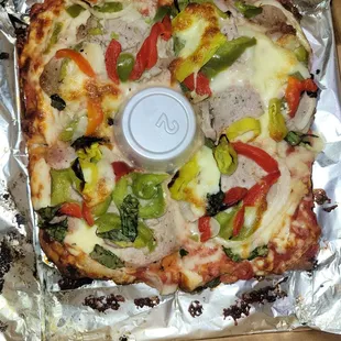 Sicilian crust pizza with red &amp; green bell pepper, basil, sausage, pepperocini, garlic