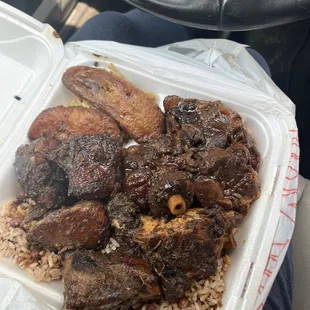 Double meat combo with Jerk Chicken and oxtail, rice and peas with Fried Plantain and Cabbage.